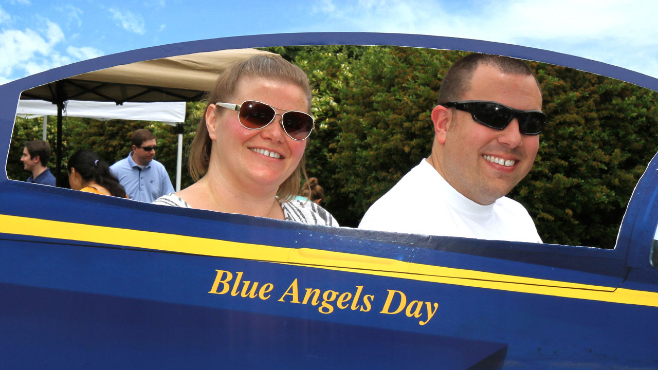 Couple pose inside blue angels plane