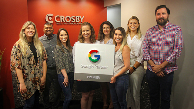 Crosby Team holding Google Premier Partner Sign